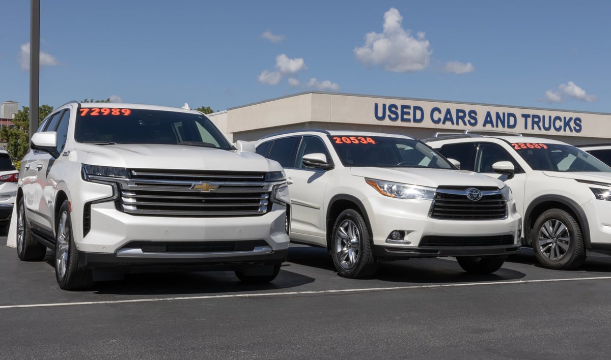 Used car display at a dealership forecourt with rows of vehicles for sale